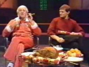 "Now then, this turkey wot we have got 'ere, and these very fine Christmas crackers, mean me and me old mucker Peter are all set to celebrate Christmas in some style. Lovely! But, you see, last year, the Duchess forgot to switch off the oven, so we had cinders for Christmas, and it wasn't a ball - let me tell you! Urrgh! Urrgh! Talking about cinders, here's a very talented young man by the name of David Bowie and his track is called 'Ashes to Ashes'. How's about that then?"
